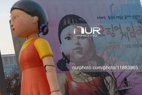 Young-hee, a robotic doll from Netflix's mega-hit ''Squid Game,'' and a billboard for Netflix's ''Squid Game'' new season are seen at Gwangh...