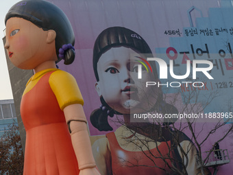 Young-hee, a robotic doll from Netflix's mega-hit ''Squid Game,'' and a billboard for Netflix's ''Squid Game'' new season are seen at Gwangh...