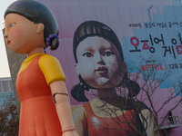 Young-hee, a robotic doll from Netflix's mega-hit ''Squid Game,'' and a billboard for Netflix's ''Squid Game'' new season are seen at Gwangh...