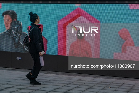 A person walks past a displayed billboard for Netflix's ''Squid Game'' new season in Seoul, South Korea, on December 20, 2024. ''Squid Game'...