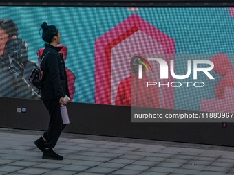 A person walks past a displayed billboard for Netflix's ''Squid Game'' new season in Seoul, South Korea, on December 20, 2024. ''Squid Game'...