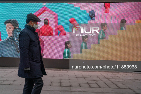 A person walks past a displayed billboard for Netflix's ''Squid Game'' new season in Seoul, South Korea, on December 20, 2024. ''Squid Game'...