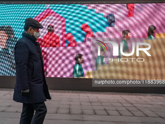 A person walks past a displayed billboard for Netflix's ''Squid Game'' new season in Seoul, South Korea, on December 20, 2024. ''Squid Game'...