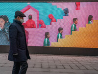 A person walks past a displayed billboard for Netflix's ''Squid Game'' new season in Seoul, South Korea, on December 20, 2024. ''Squid Game'...