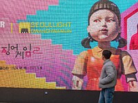 A person walks past a displayed billboard for Netflix's ''Squid Game'' new season in Seoul, South Korea, on December 20, 2024. ''Squid Game'...