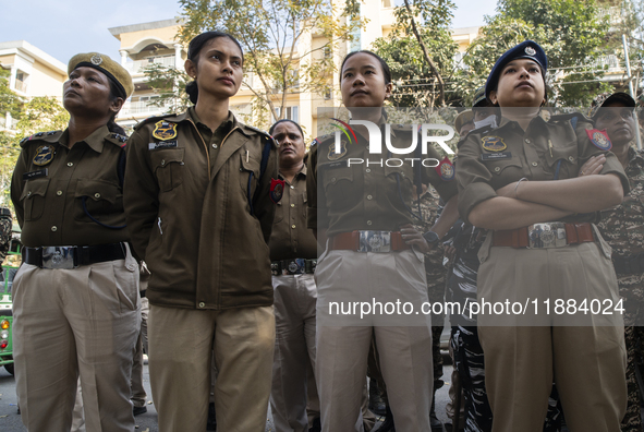 Assam police personnel stand guard during an Indian Youth Congress protest against the state government over the death of a party worker in...