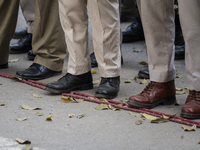 Assam police personnel stand guard during an Indian Youth Congress protest against the state government over the death of a party worker in...