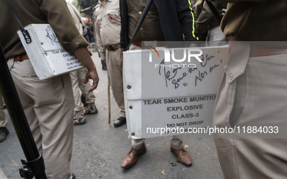 Police prepare with tear gas during the Indian Youth Congress protest against the state government over the death of a party worker in Guwah...