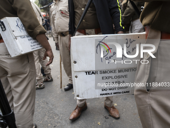 Police prepare with tear gas during the Indian Youth Congress protest against the state government over the death of a party worker in Guwah...