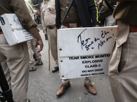 Police prepare with tear gas during the Indian Youth Congress protest against the state government over the death of a party worker in Guwah...