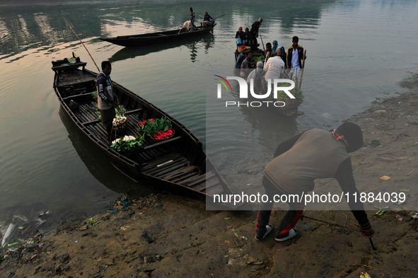 Local vegetable cultivators bring their vegetables to the local wholesale vegetable market after transporting them on a boat in the Tooker B...