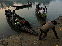 Local vegetable cultivators bring their vegetables to the local wholesale vegetable market after transporting them on a boat in the Tooker B...