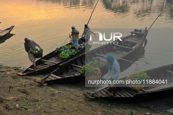 Local vegetable cultivators bring their vegetables to the local wholesale vegetable market after transporting them on a boat in the Tooker B...