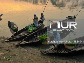 Local vegetable cultivators bring their vegetables to the local wholesale vegetable market after transporting them on a boat in the Tooker B...