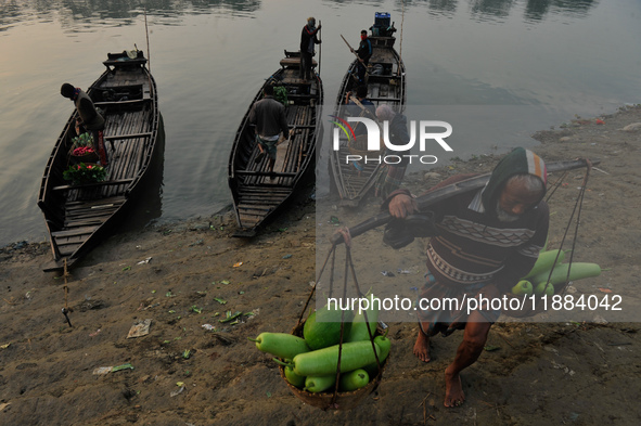 Local vegetable cultivators bring their vegetables to the local wholesale vegetable market after transporting them on a boat in the Tooker B...