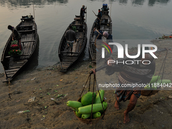 Local vegetable cultivators bring their vegetables to the local wholesale vegetable market after transporting them on a boat in the Tooker B...