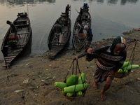 Local vegetable cultivators bring their vegetables to the local wholesale vegetable market after transporting them on a boat in the Tooker B...