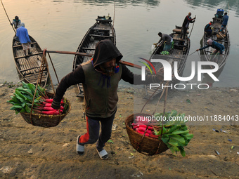 Local vegetable cultivators bring their vegetables to the local wholesale vegetable market after transporting them on a boat in the Tooker B...