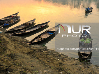 Local vegetable cultivators bring their vegetables to the local wholesale vegetable market after transporting them on a boat in the Tooker B...