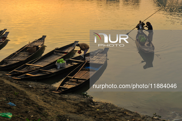 Local vegetable cultivators bring their vegetables to the local wholesale vegetable market after transporting them on a boat in the Tooker B...