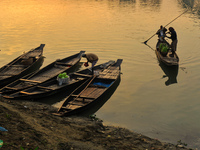 Local vegetable cultivators bring their vegetables to the local wholesale vegetable market after transporting them on a boat in the Tooker B...