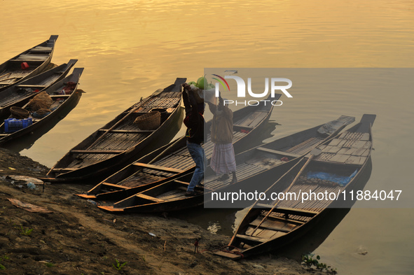 Local vegetable cultivators bring their vegetables to the local wholesale vegetable market after transporting them on a boat in the Tooker B...