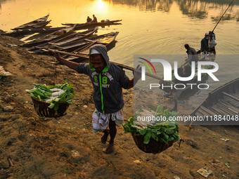 Local vegetable cultivators bring their vegetables to the local wholesale vegetable market after transporting them on a boat in the Tooker B...