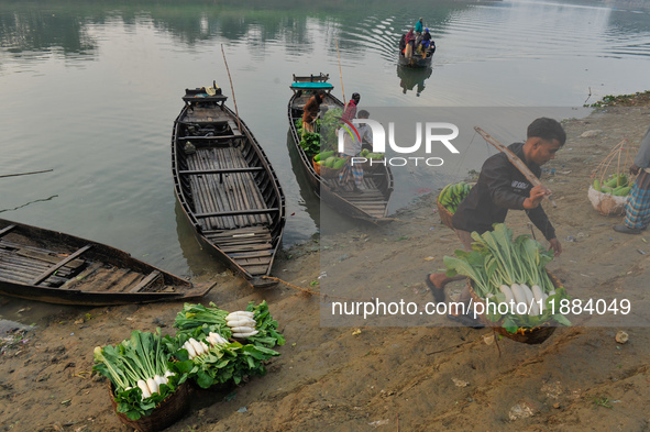 Local vegetable cultivators bring their vegetables to the local wholesale vegetable market after transporting them on a boat in the Tooker B...