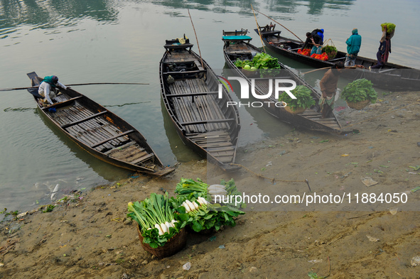 Local vegetable cultivators bring their vegetables to the local wholesale vegetable market after transporting them on a boat in the Tooker B...