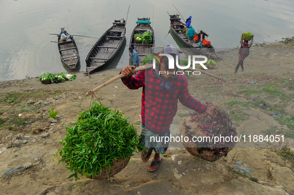 Local vegetable cultivators bring their vegetables to the local wholesale vegetable market after transporting them on a boat in the Tooker B...