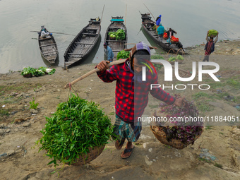 Local vegetable cultivators bring their vegetables to the local wholesale vegetable market after transporting them on a boat in the Tooker B...