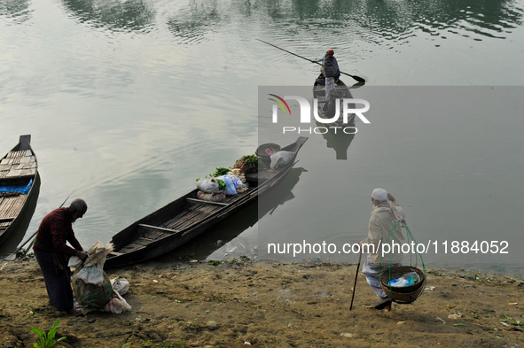 Local vegetable cultivators bring their vegetables to the local wholesale vegetable market after transporting them on a boat in the Tooker B...