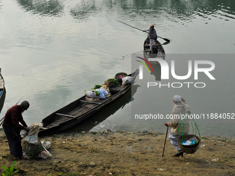 Local vegetable cultivators bring their vegetables to the local wholesale vegetable market after transporting them on a boat in the Tooker B...