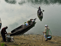 Local vegetable cultivators bring their vegetables to the local wholesale vegetable market after transporting them on a boat in the Tooker B...