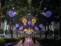 People walk on an illuminated street in Jakarta, Indonesia, on December 20, 2024. The world's most populous Muslim country prepares for Chri...