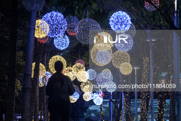 People walk on an illuminated street in Jakarta, Indonesia, on December 20, 2024. The world's most populous Muslim country prepares for Chri...