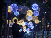 People walk on an illuminated street in Jakarta, Indonesia, on December 20, 2024. The world's most populous Muslim country prepares for Chri...