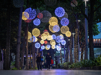 People walk on an illuminated street in Jakarta, Indonesia, on December 20, 2024. The world's most populous Muslim country prepares for Chri...