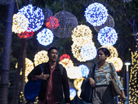 People walk on an illuminated street in Jakarta, Indonesia, on December 20, 2024. The world's most populous Muslim country prepares for Chri...