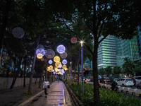 People walk on an illuminated street in Jakarta, Indonesia, on December 20, 2024. The world's most populous Muslim country prepares for Chri...