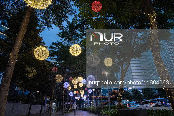 People walk on an illuminated street in Jakarta, Indonesia, on December 20, 2024. The world's most populous Muslim country prepares for Chri...