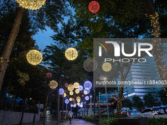 People walk on an illuminated street in Jakarta, Indonesia, on December 20, 2024. The world's most populous Muslim country prepares for Chri...