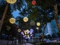 People walk on an illuminated street in Jakarta, Indonesia, on December 20, 2024. The world's most populous Muslim country prepares for Chri...