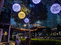 People walk on an illuminated street in Jakarta, Indonesia, on December 20, 2024. The world's most populous Muslim country prepares for Chri...