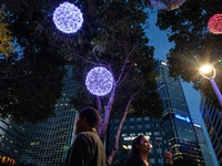 People walk on an illuminated street in Jakarta, Indonesia, on December 20, 2024. The world's most populous Muslim country prepares for Chri...