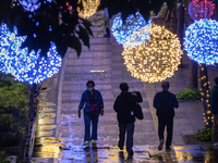 People walk on an illuminated street in Jakarta, Indonesia, on December 20, 2024. The world's most populous Muslim country prepares for Chri...