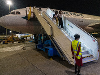 Passengers disembark on the tarmac from an Airbus A330 of Cathay Pacific flying from Hangzhou, China, in Hong Kong, China, on October 5, 202...