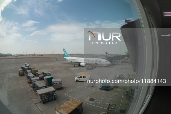 A Boeing 737 of Greater Bay Airlines is at the gate in this fisheye picture in Hong Kong, China, on November 3, 2024. 