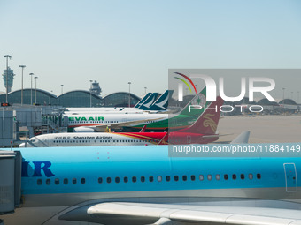 Planes park at the gate in the Hong Kong International Airport in Hong Kong, China, on December 1, 2024. (