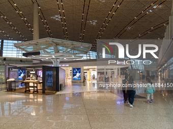 Passengers walk through a deserted Beijing Capital International Airport in Beijing, China, on December 1, 2024. (